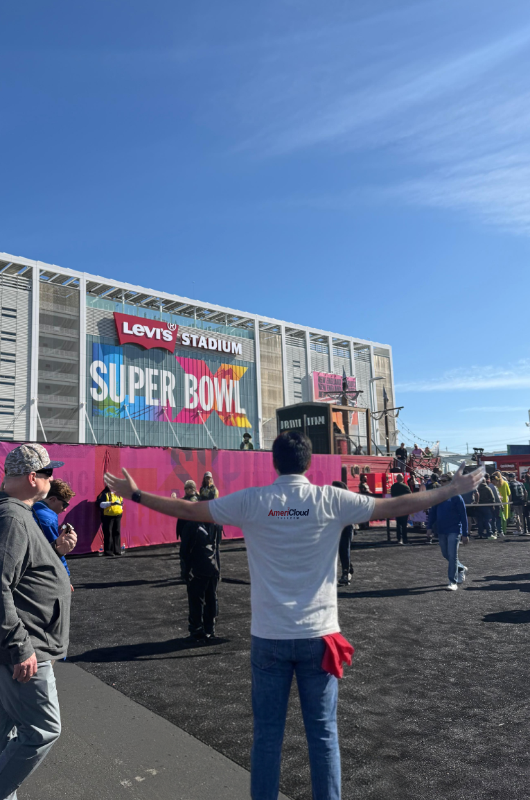 AmeriCloud staffer in front of a Super Bowl stadium