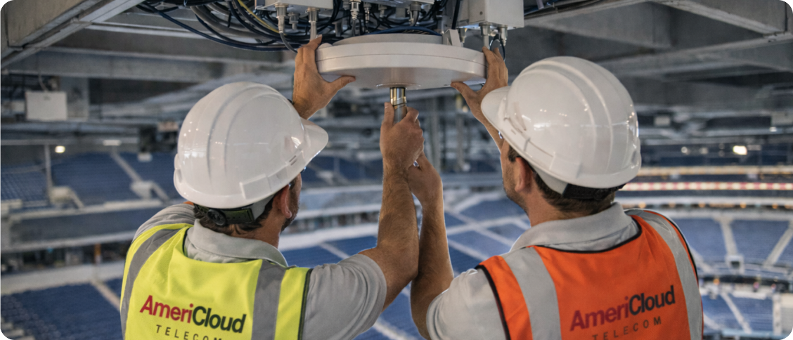 AmeriCloud technicians installing a ceiling antenna in a stadium